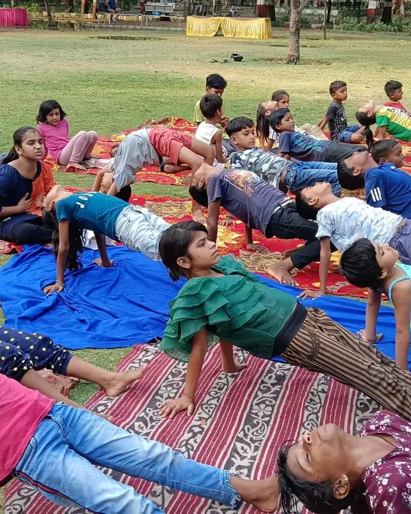 Children from a local NGO practicing Purvottanasana (Upward Plank Pose) during our International Yoga Day celebration. This asana is great for strengthening the arms, wrists, and legs.