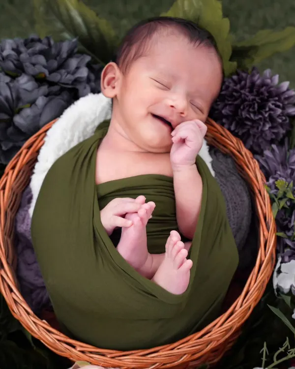 A precious moment of pure joy captured as this little one dreams. I focus on getting these fleeting smiles, which requires patience and a gentle touch, ensuring the baby is completely comfortable and happy.