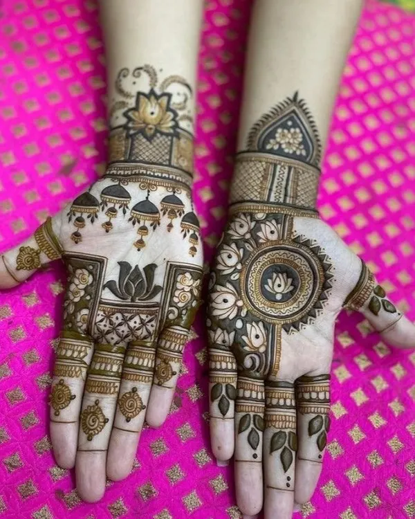 A beautiful design featuring a central mandala on one hand and hanging 'jhumki' motifs on the other. Both hands are tied together with the common element of the lotus flower.