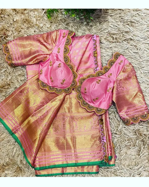This is a complete mother-daughter twinning set I designed for a client's special occasion. It features a traditional pink and gold silk saree with two hand-embroidered blouses, one for the mother and a matching one for her little girl, creating a cohesive and elegant family look.