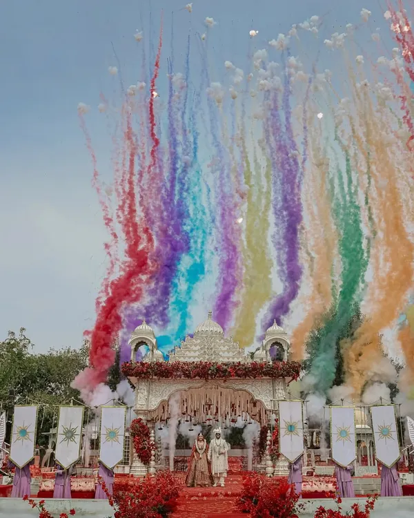 A sky painted with the colors of your love. This is how I make your varmala moment iconic, using vibrant smoke effects to create a backdrop as unique and beautiful as your story.