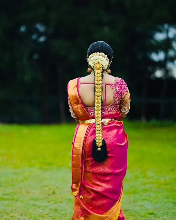 This is my signature South Indian bridal hairstyle. I created a thick, traditional braid and adorned it with a full gold-plated jada set, perfect for a classic muhurtham look that feels both royal and timeless.