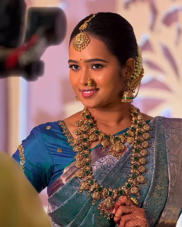 This is the complete traditional bridal look my clients love. This beautiful bride is wearing one of my handpicked antique temple jewellery sets, featuring intricate goddess motifs and green stones that perfectly complement her silk saree for her muhurtham.