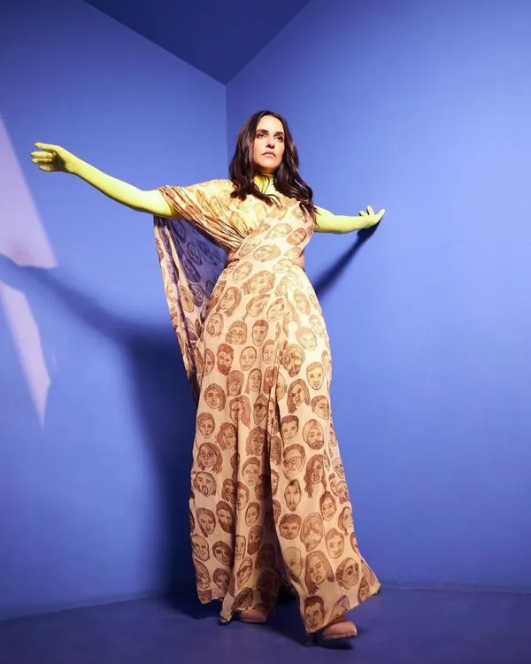 A full-length view of this artistic ensemble. The flowing, printed fabric paired with bright neon gloves creates a look that is both a fashion statement and a piece of performance art.