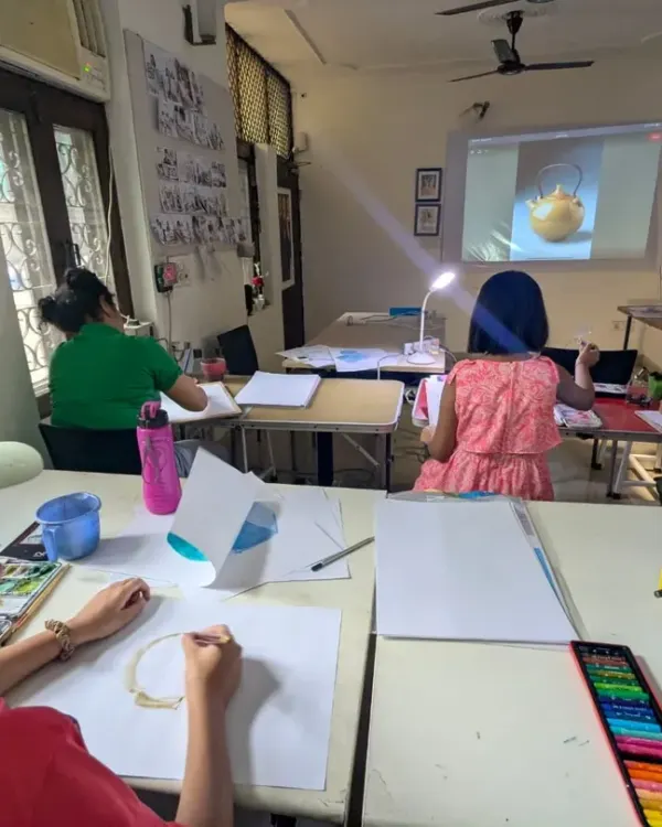 A snapshot of a typical class in our studio. Students are focused on their still life paintings, using a mix of digital projections and real objects for reference.