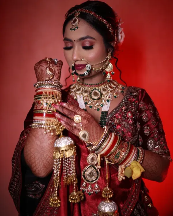 This is the look every bride dreams of. I focused on creating flawless, radiant skin with shimmering eyes and a bold lip, perfectly complementing her magnificent kundan jewelry and traditional red lehenga. This North Indian bridal makeup is all about making you feel like royalty on your special day.