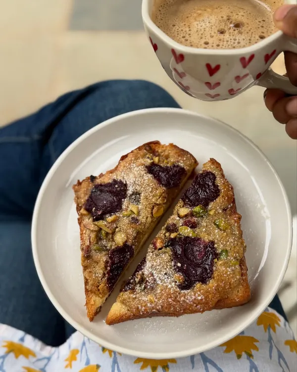 A cozy moment with late-night baking therapy: pistachio bostock with nerale (jamun) jam and a warm drink.