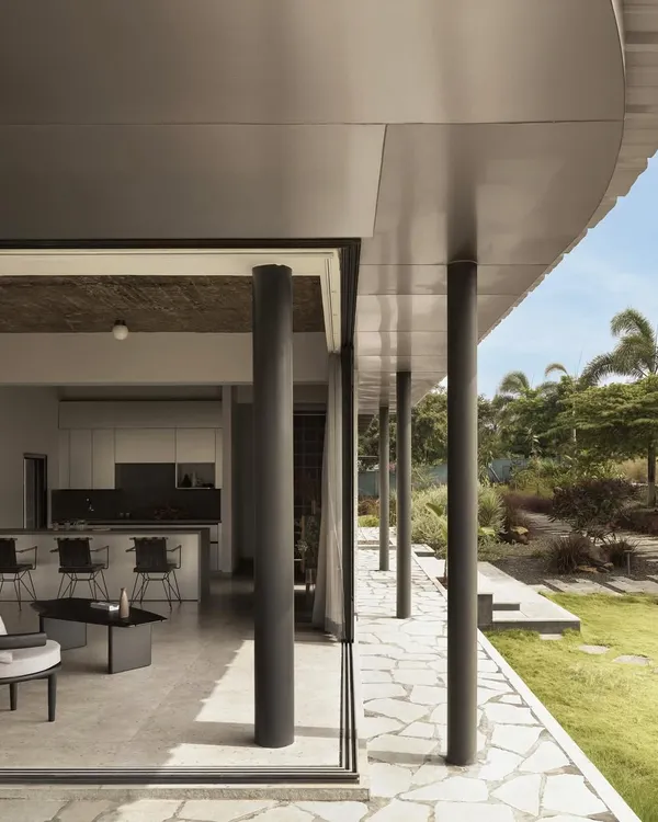 This is Pavilion House, our prairie-style retreat in Nashik. We designed this low-lying home to merge with the landscape, creating a visceral connection between the structure and its semi-arid surroundings. The expansive glass and open living spaces are central to our belief in architecture that breathes.