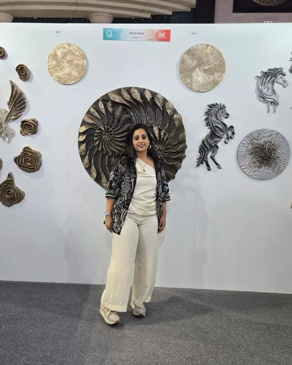 Standing with my work at the art show in Qatar. The collection on display includes my signature sculptural pieces like the large nautilus, horses, and textured floral forms.