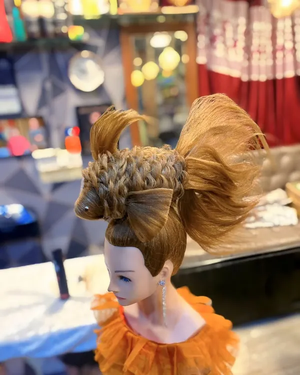 An example of my creative hairstyling work, a fish sculpture made entirely of hair. This avant garde piece showcases advanced techniques in hair shaping and texturing.