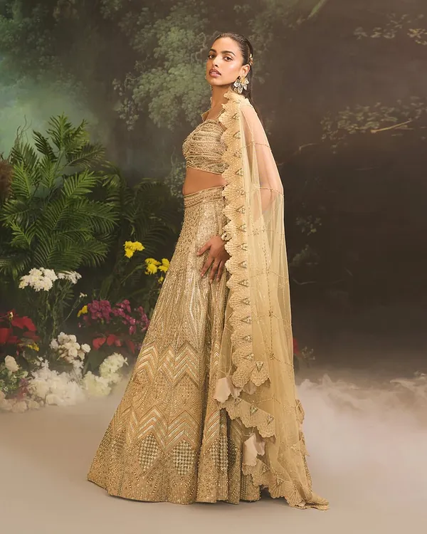 The Jade Lehenga Set in all its glory. This fully embellished ombre gold lehenga is paired with a matching blouse and a scalloped net dupatta, perfect for a bride or for a grand festive occasion.