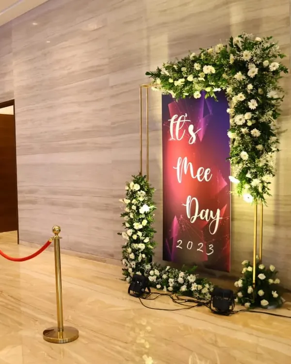 This custom-branded photo booth for "It's Mee Day 2023" provided a fun and interactive element for guests. The floral frame and professional lighting created a perfect spot for memorable photos at the corporate evening event.
