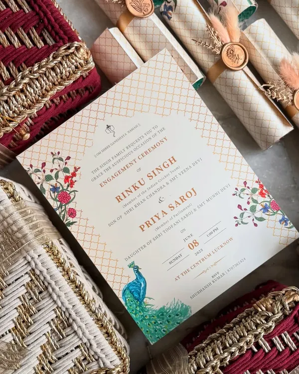 This exquisite engagement invitation set we designed for cricketer Rinku Singh and MP Priya Saroj features a regal peacock motif. The hamper includes handwoven boxes and elegant invitation scrolls, setting a tone of opulence for the celebration.