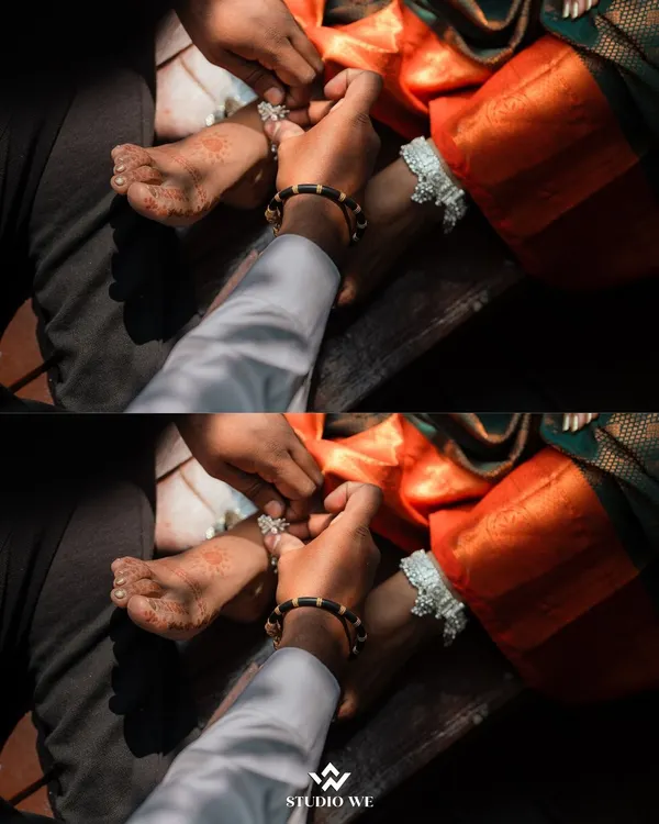 A close-up shot of the groom placing the toe ring on the bride's foot, a significant ritual in many Indian weddings. We capture these traditional details with reverence and artistry.