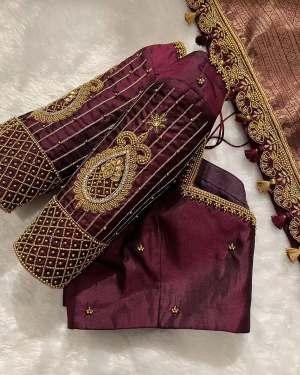 Sparkle brighter than ever. This bridal blouse features heavy zardosi and beadwork on the sleeves for a truly regal look.