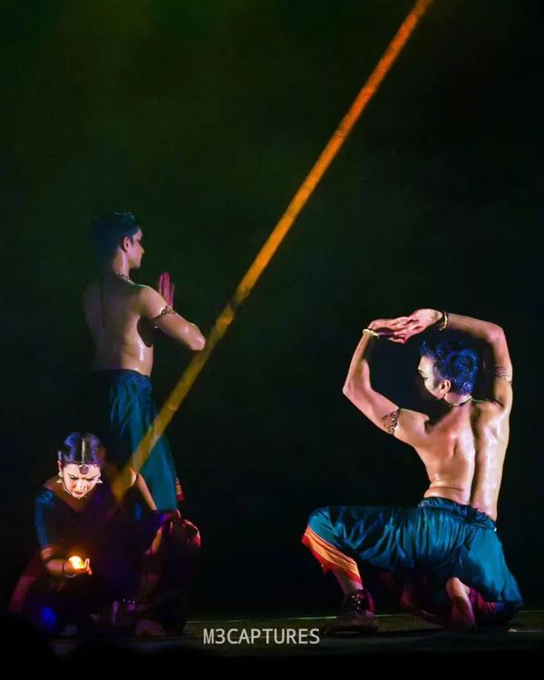 A dramatic moment from 'Nagamandala', a production by Punyah Dance Company. The lighting here, a single beam, creates a powerful focal point in the story.
