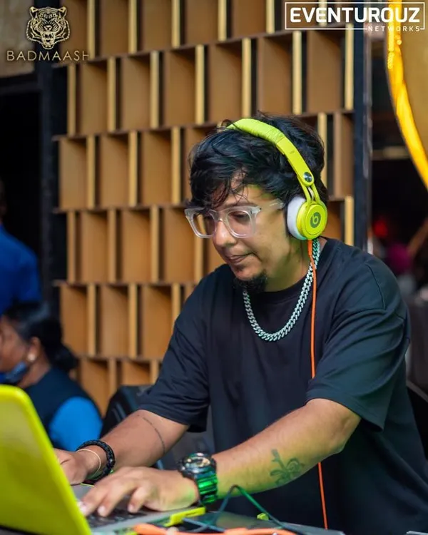 Focused on the mix at Badmaash in Koramangala. I am fine-tuning the tracks on my laptop, ensuring a seamless flow of music for the crowd.