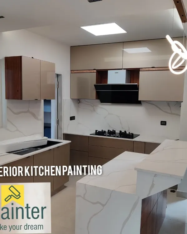 A stunning modern kitchen achieved with professionally painted cabinets. The smooth, beige laminate finish is paired with wood accents for a sophisticated, two-tone effect.