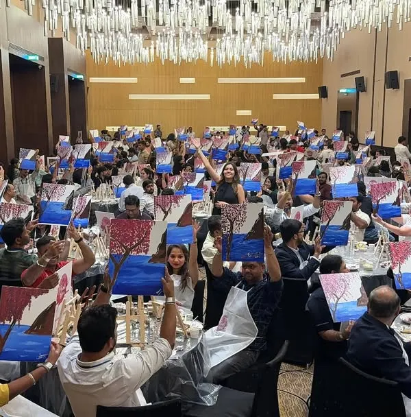 This is what it looks like to have 230 people painting together at one of my Paint Bar workshops. I've learned how to manage events of this scale, and it's one of the key things I teach: how to go from a small gathering to a massive, successful event.