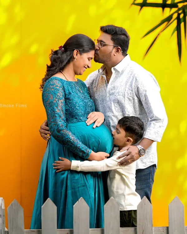 Welcoming a new member to the family is a joy for everyone. We captured this beautiful moment with the mom-to-be, dad, and their excited older son during a vibrant studio maternity session. These are the memories that last a lifetime.