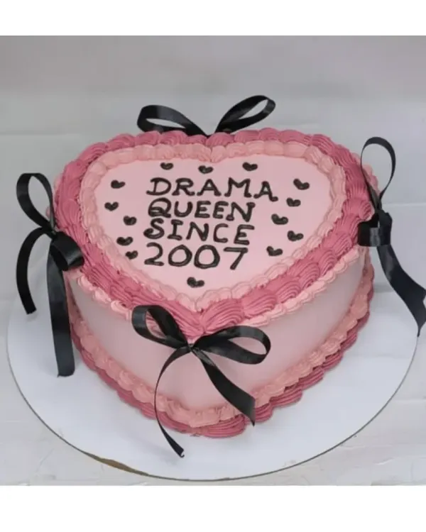 For the "Drama Queen Since 2007"! This vintage-style heart-shaped cake is a choco-blueberry flavor, decorated with pink and black piping and ribbons.