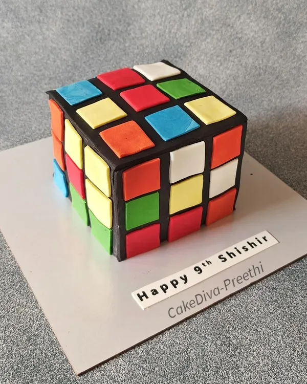 Rubik's Cube or cake? This was a fun challenge. I carved a square chocolate truffle cake and covered it with black fondant, then carefully placed each colored square to replicate the iconic puzzle.
