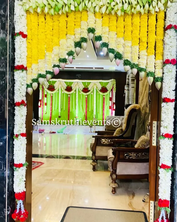 A welcoming entrance to a home event, beautifully decorated with an arch of yellow and white flowers. This shows how I can transform any space, big or small.