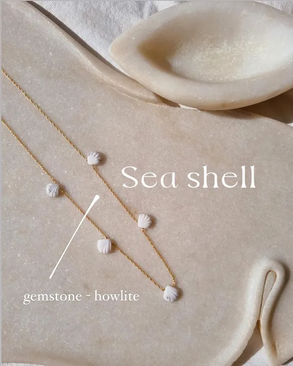 My beach shell collection, featuring this Howlite choker. The small, carved shells are spaced along a delicate chain, bringing the calming energy of the ocean with you.