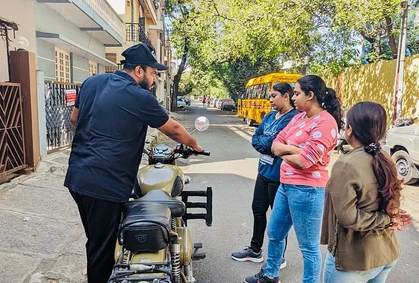 Personal instruction is key. Here, I'm explaining the bike's controls to a small group of new learners, ensuring everyone is comfortable and understands the basics before we start riding.