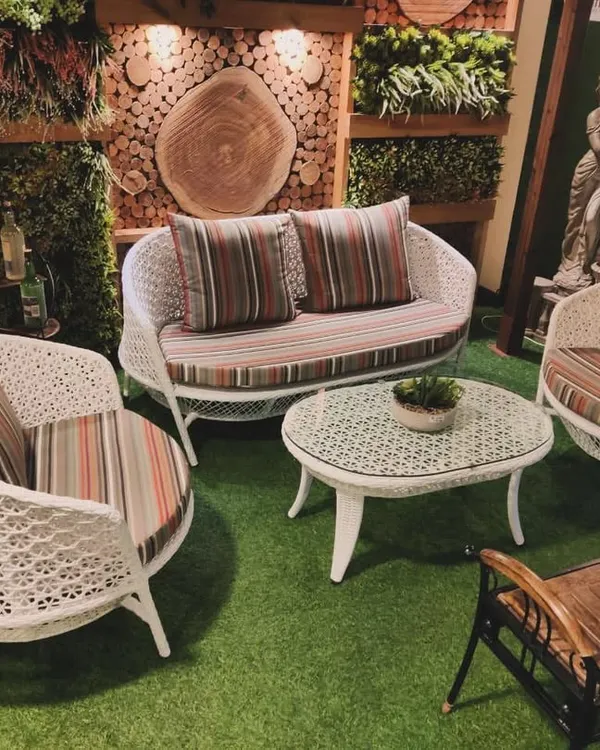This is the lifestyle I create. Imagine your own outdoor space transformed with this elegant white wicker sofa set, complete with plush striped cushions, all set on a maintenance-free artificial lawn. This is the perfect setup for enjoying cozy evenings or hosting friends in style.