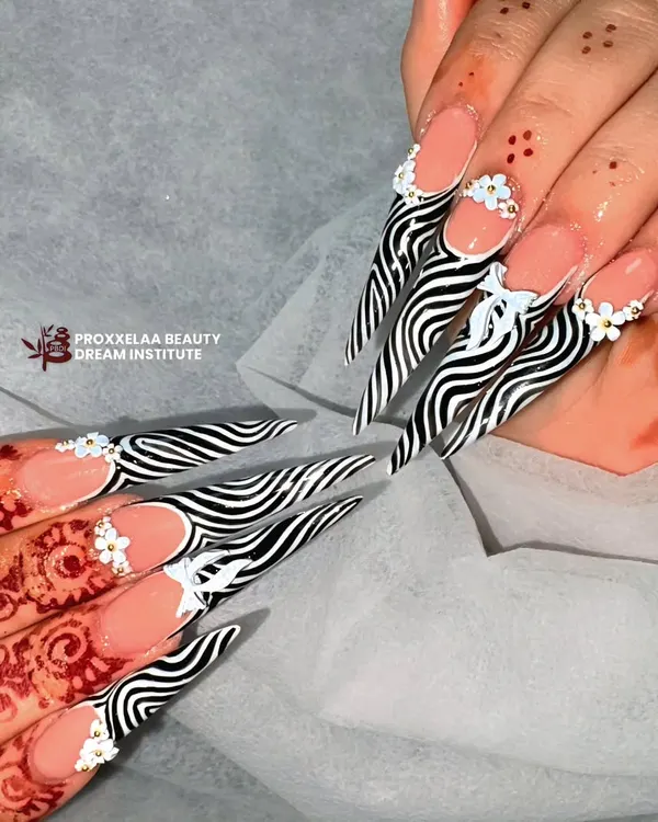 For a look that's fierce and fabulous, I hand-painted this high-contrast zebra print on dramatic stiletto extensions. The clean lines and sharp shape make a bold statement.