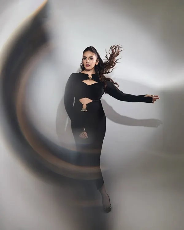 Huma Qureshi in a powerful black dress by Label Riya. The strategic cutouts and long sleeves create a silhouette that is both elegant and edgy, captured here with a dynamic motion blur.
