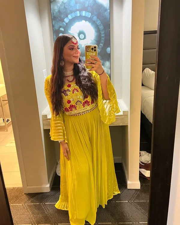 A client looking like a ray of sunshine in this yellow embroidered outfit. She paired it with a delicate white choker and matching earrings, creating a beautiful and bright festive look.