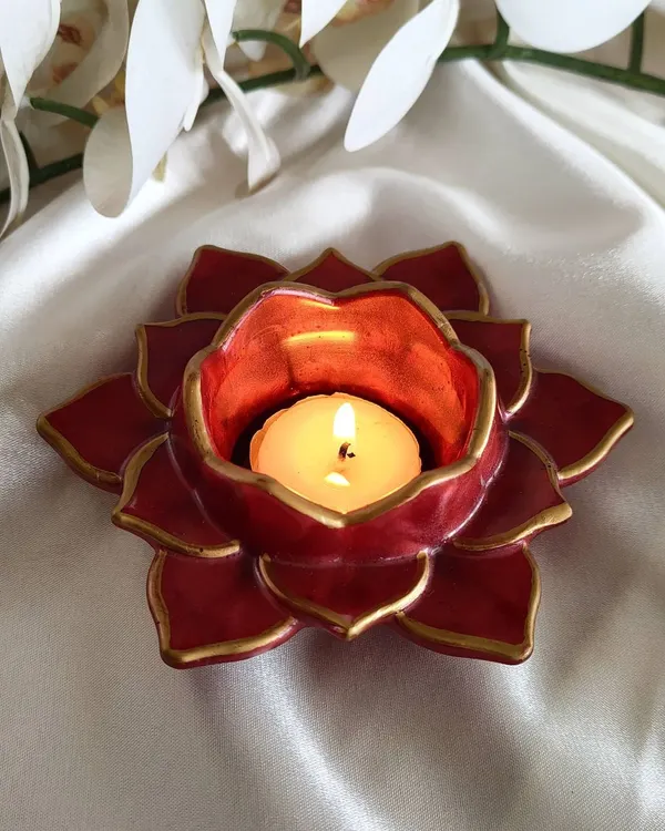 This red and gold lotus T-light holder was a popular item for Diwali. The rich color and hand-painted gold edges bring a traditional and festive feel to your home.