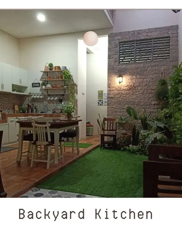 We can integrate green spaces anywhere in your home, even next to the kitchen. This design shows how a small patch of green with a brick accent wall can bring life and a natural feel to an indoor dining area.