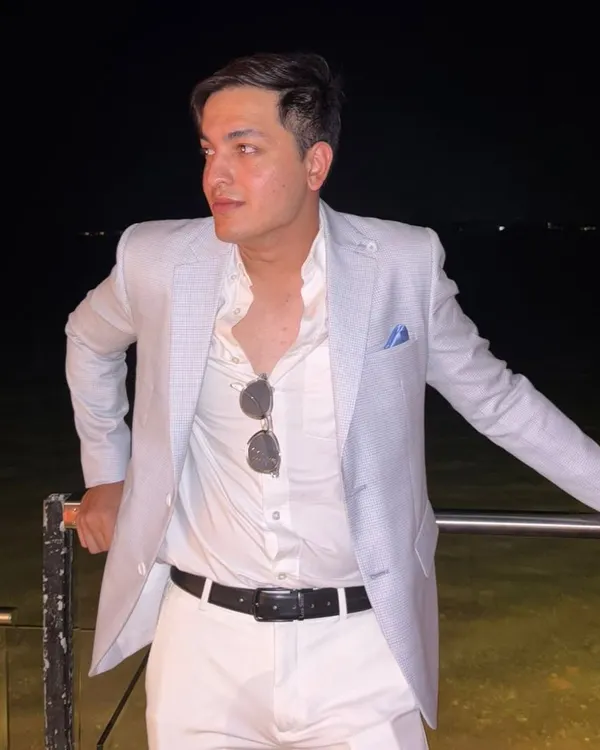 A client enjoying an evening by the water in an arctic blue linen jacket. This is the perfect look for a destination wedding or a landmark birthday party, effortlessly stylish and comfortable.