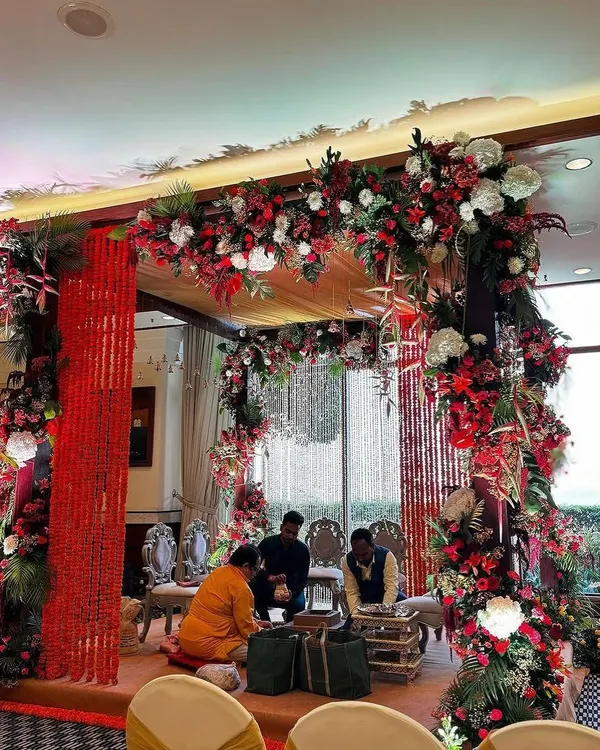 A grand and luxurious wedding mandap decoration. I used a rich combination of red and white flowers, red fabric strings, and elegant seating to create this beautiful ceremony space.
