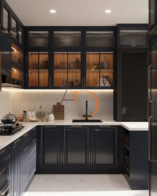 This U-shaped modular kitchen showcases a sophisticated blend of rich navy blue PU-finished cabinetry and warm wood tones. Features like fluted glass shutters, under-cabinet LED lighting, and a clean white quartz countertop demonstrate a perfect balance of luxury and high-functioning kitchen design.