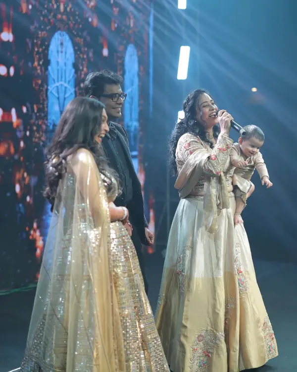This picture is everything to me. On stage, mic in one hand, my baby in the other, hosting a Sangeet. This is the 'Mommy Anchor' energy I bring to every event, proving that passion and motherhood can go hand in hand to create something truly special.