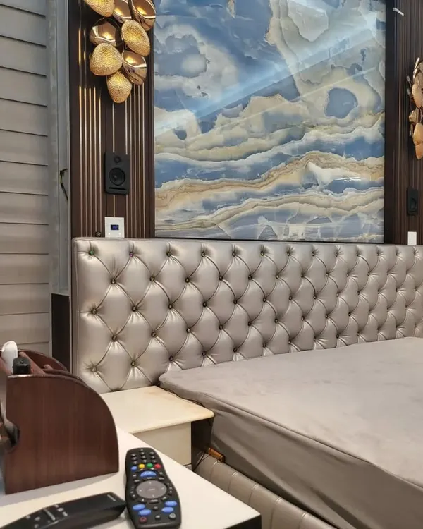 This is the result of a recent wireless home theater installation in a Banashankri, Bengaluru residence. I wall-mounted the rear surround speakers on either side of the headboard, creating an immersive audio experience right in the bedroom without any visible wiring. The setup blends perfectly with the room's elegant interior design.