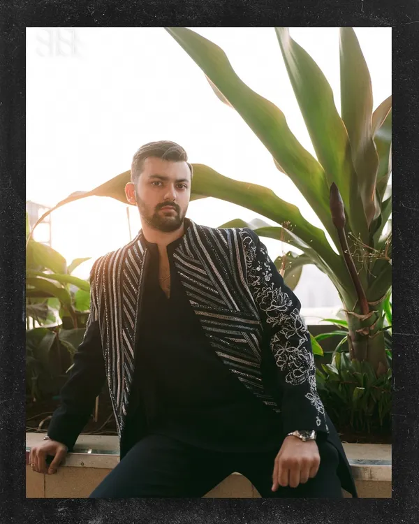 A groom's portrait just before the Sangeet madness begins. This shot captures Kushal looking sharp and ready for the celebration, with a great blend of ambient light and stylish composition.