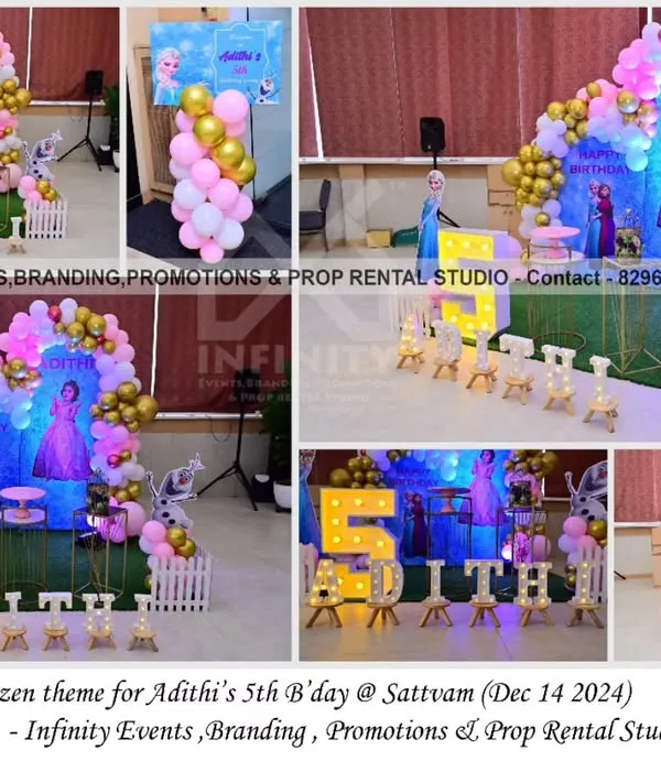 A classic Frozen theme for a fifth birthday at Sattvam. The setup includes a character backdrop with Elsa and Anna, a pink and gold balloon garland, and a light-up number "5".