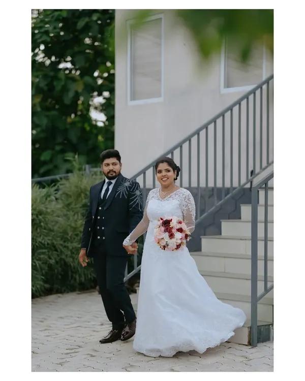 The bride and groom walk hand in hand, a perfect picture of modern elegance. This is a classic wedding portrait that captures the beginning of their journey together.