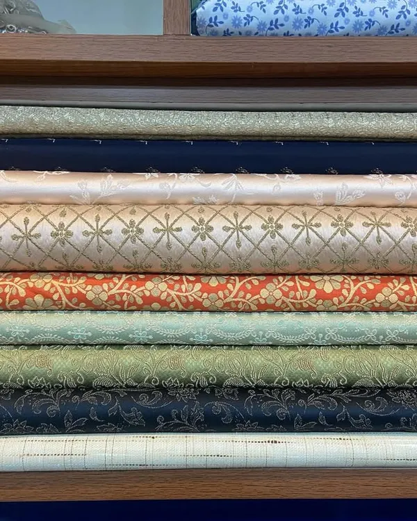 Your custom outfit starts here, with the fabric. This is a glimpse of my collection of rolled brocade and silk-blend textiles, featuring a variety of colors and woven patterns perfect for creating unique sherwanis and Jodhpuri suits.