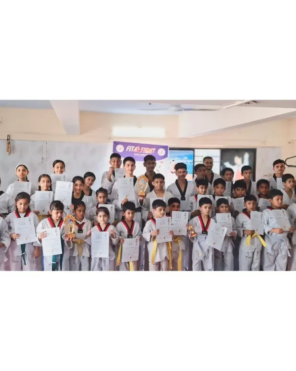 The proud graduates of our latest belt exam. Each student holds their certificate, marking a significant step forward in their Taekwondo journey.