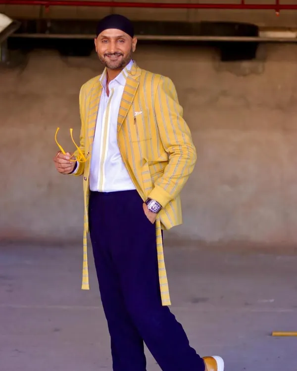 A dapper dream. Cricketer Harbhajan Singh looks sharp in this custom-crafted yellow striped blazer set. It's a defined and confident look that I was proud to create for him.