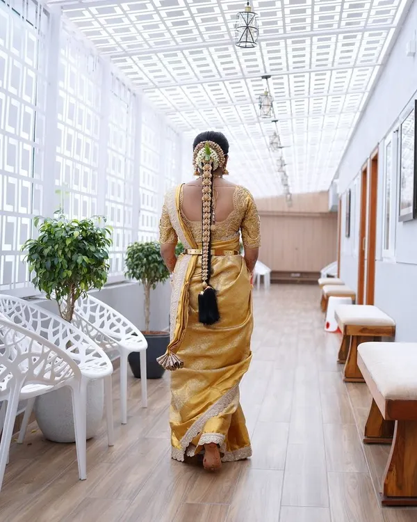 This is the quintessential South Indian bridal look I love to create. The focus is on the magnificent traditional braid, or poola jada, perfectly complemented by a classic silk saree. It’s a look of pure elegance and heritage.