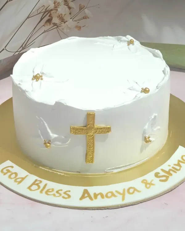 A simple and elegant confirmation cake. The pristine white design is accented with a golden cross and delicate white doves.