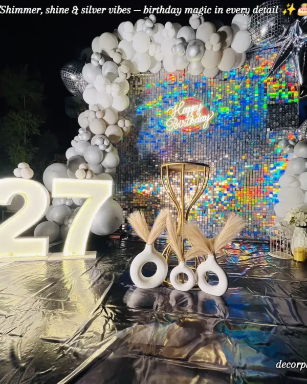 For a 27th birthday that needed to be extra glamorous, we designed this stunning silver sequin backdrop. The glowing marquee numbers and modern pampas grass decor created a chic, photo-perfect spot for a night of celebration.