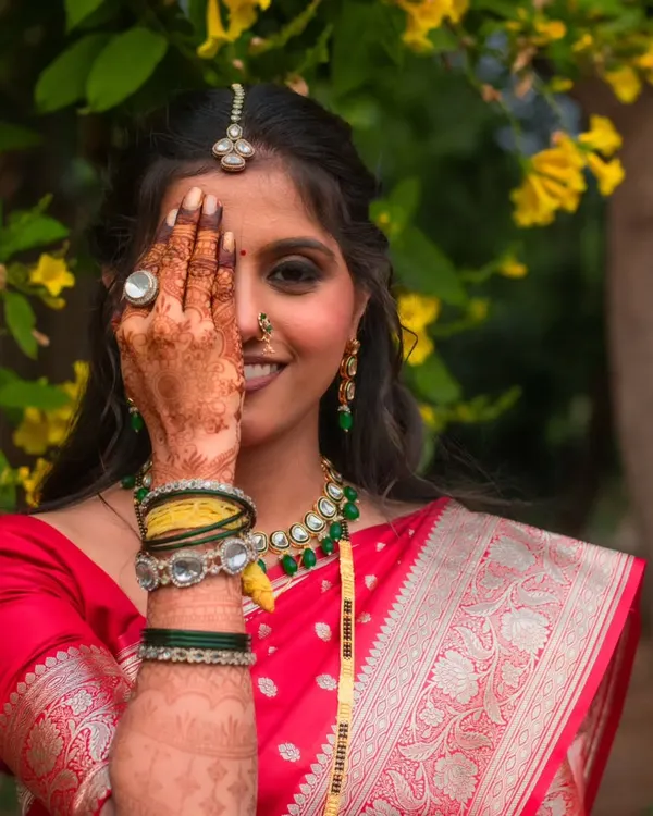 A playful and radiant moment with this beautiful bride. I focused on creating a dramatic smokey eye that shines through, complemented by her traditional Maharashtrian jewelry and intricate henna design.